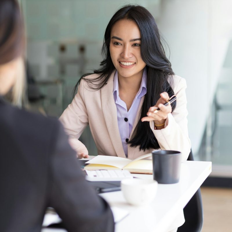 Businesswoman discussing with colleagues in the office, job interview.